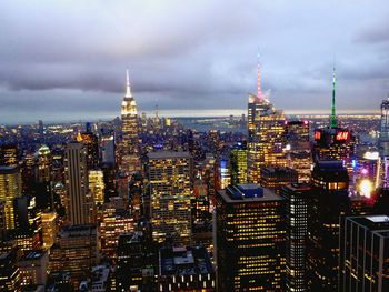 Illuminated buildings in city against sky at night