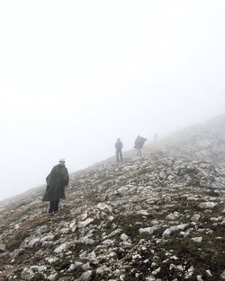 People on mountain during foggy weather