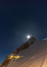 Scenic view of snowcapped mountains against sky at night