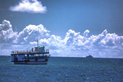 Ship sailing in sea against sky