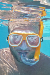 Portrait of man snorkeling in swimming pool