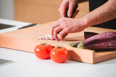 Close-up of man preparing food on cutting board