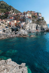 Townscape by sea against clear sky