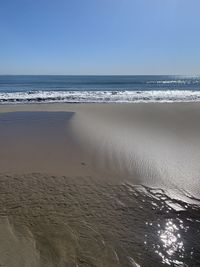 Scenic view of beach against clear sky