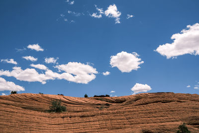 Low angle view of arid landscape against sky