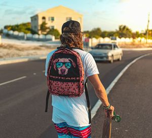 Rear view of man standing on road