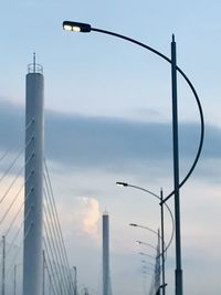 Low angle view of illuminated street light against sky