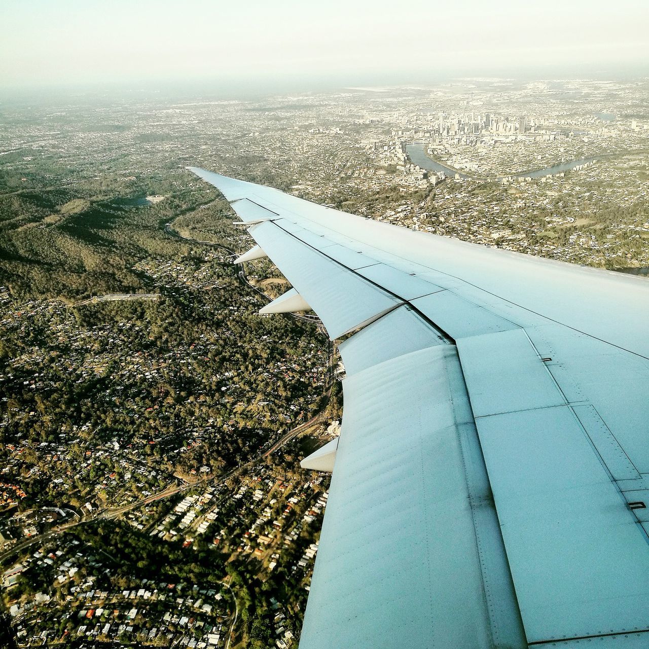 AERIAL VIEW OF AIRPLANE WING OVER LANDSCAPE