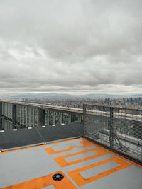 High angle view of city by sea against sky