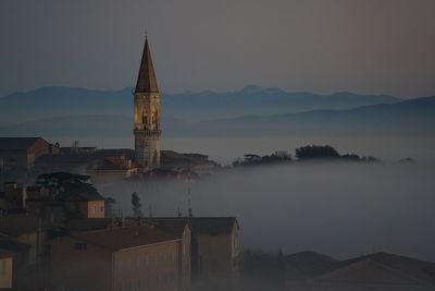 Aerial view of church spire against mountain range