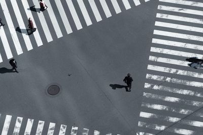 High angle view of people crossing road