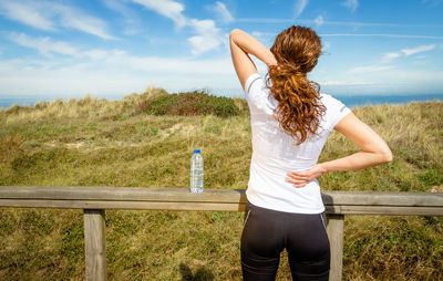 Rear view of woman standing on field