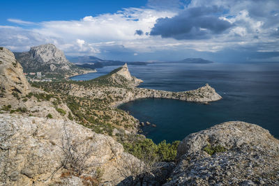 Mount falcon lit by pink sunset in novyi svit. sudak, the republic of crimea. aerial view