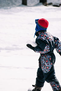 Boy on snow covered field