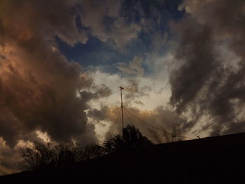 Low angle view of silhouette landscape against sky