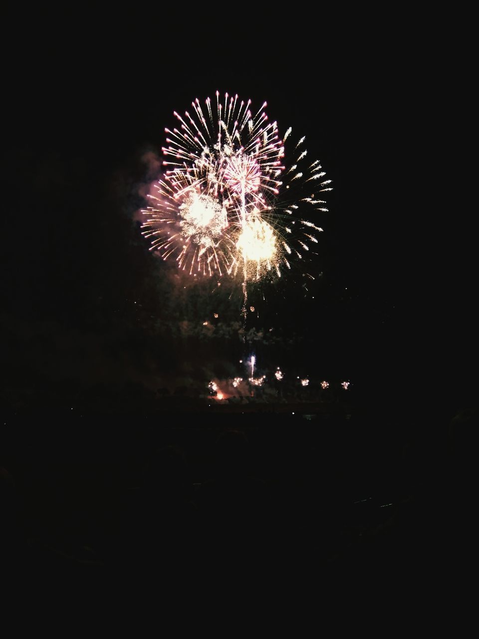 night, illuminated, firework display, long exposure, exploding, motion, firework - man made object, glowing, celebration, sparks, arts culture and entertainment, blurred motion, event, firework, sky, entertainment, low angle view, fire - natural phenomenon, celebration event, smoke - physical structure