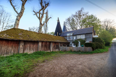 Exterior of building by trees against sky