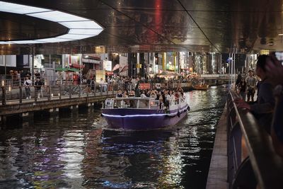 Boat on canal in city at night