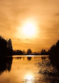 Scenic view of lake against orange sky