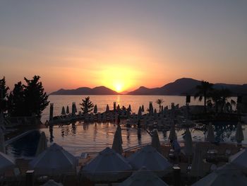 Resort by sea against clear sky during sunset at oludeniz