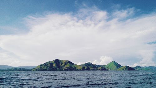 Panoramic view of sea and mountains against sky