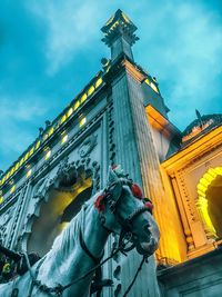 Low angle view of statue against historic building