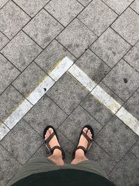 Low section of man standing on footpath