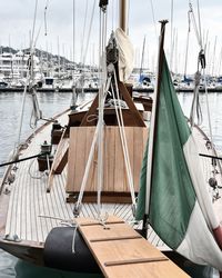 Boats moored at harbor against sky