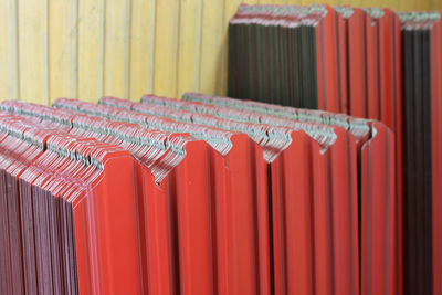 Close-up of red corrugated iron sheets at warehouse