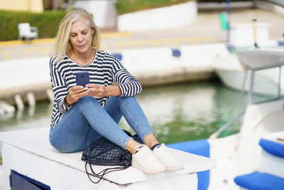 Portrait of young woman sitting in boat