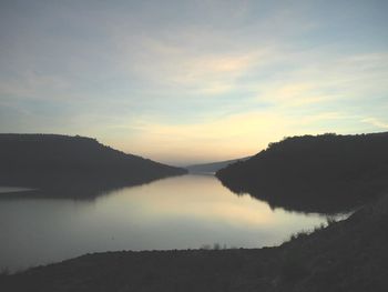 Scenic view of lake against sky during sunset