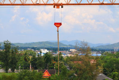 Street light by building against sky