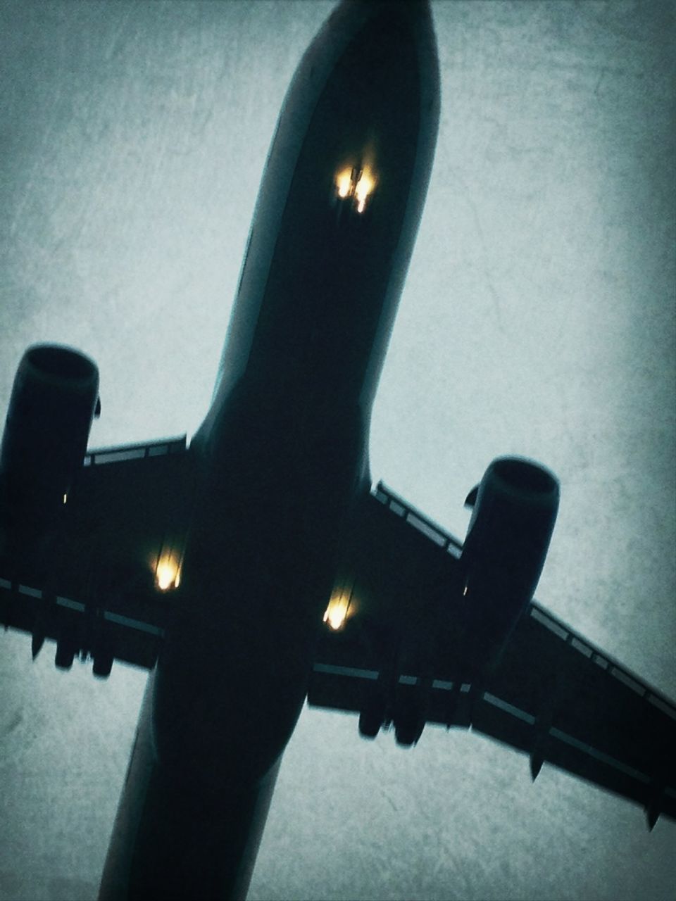 indoors, low angle view, illuminated, built structure, reflection, close-up, architecture, lighting equipment, metal, sky, no people, connection, part of, dusk, silhouette, railing, technology, night, focus on foreground