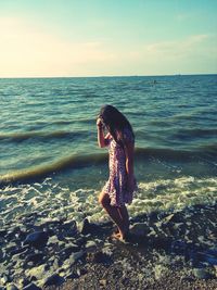 Rear view of girl standing on beach