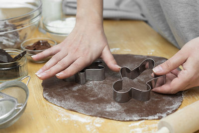 Midsection of person preparing food in kitchen