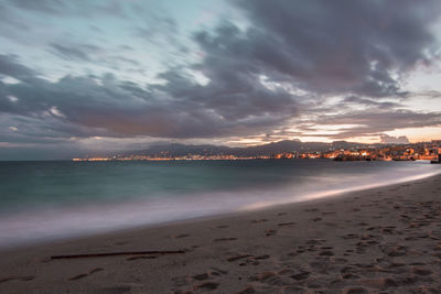 Scenic view of beach against sky during sunset