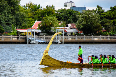 People in boat against trees