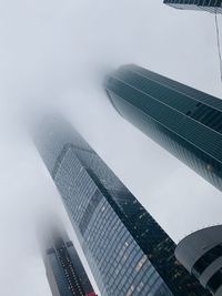 Low angle view of modern buildings against sky in city