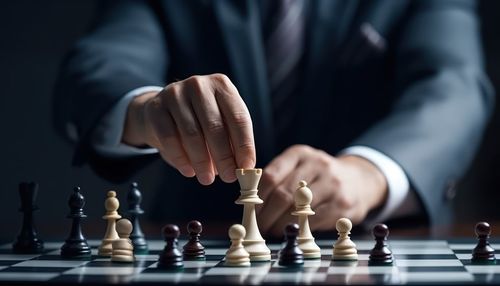 Midsection of businessman playing chess
