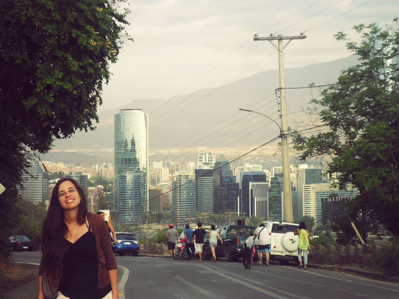 lifestyles, leisure activity, young adult, city, building exterior, architecture, built structure, person, casual clothing, young women, city life, looking at camera, men, street, skyscraper, sky