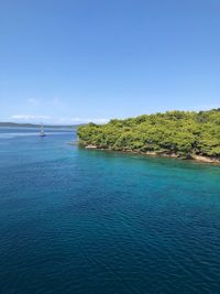 Scenic view of sea against clear blue sky