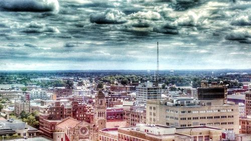 Cityscape against cloudy sky