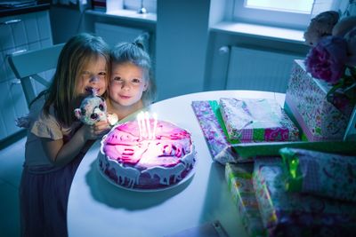 Two girls with birthday cake