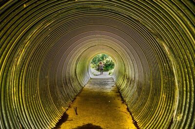 Woman seen through concrete tunnel