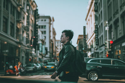 Side view of young man on city street