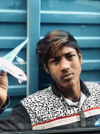 Portrait of young man holding camera