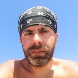 Portrait of man against blue sky