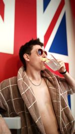 Young man drinking glass