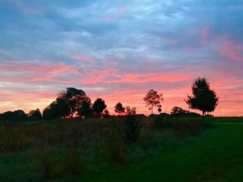 Scenic view of field against sky during sunset