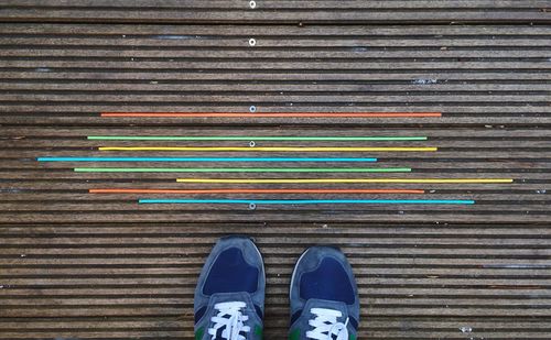 Low section view of person standing on metal grate